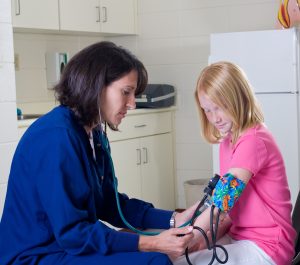 school nurse helping student using online school registration