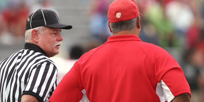 Eligible officials and coach on field