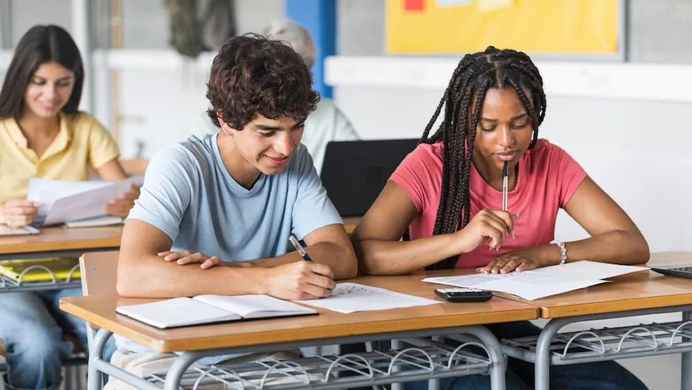a man and woman sitting at a desk